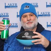 Alum with football and drink